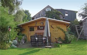 a table and chairs and an umbrella in a yard at Awesome Apartment In Remptendorf in Gleima +8 photos
