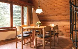 a wooden dining room with a wooden table and chairs at Amazing Home In Lbtheen With 2 Bedrooms in Probst Jesar
