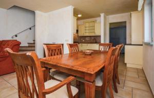 a kitchen and dining room with a wooden table and chairs at Gorgeous Home In Koper With Wifi in Koper