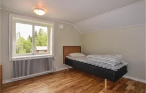 um quarto com uma cama e uma janela em 2 Bedroom Nice Home In motfors em Åmotsfors