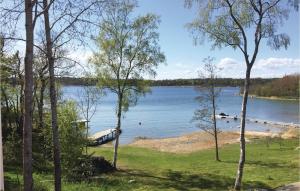 a view of a lake with a dock at Awesome Home In Grisslehamn With Kitchen in Grisslehamn