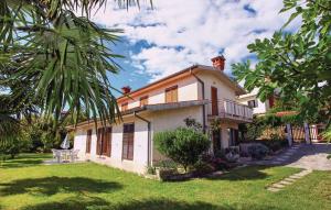 a house with a palm tree in the yard at Awesome Apartment In Portoroz With Wifi in Portorož