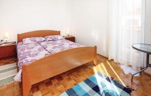a bedroom with a bed and a wooden floor at Awesome Apartment In Portoroz With Wifi in Portorož