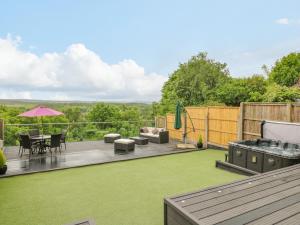 a patio with a table and chairs on a deck at Hollinwell View in Nottingham