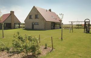 a house with a playground in a yard at Lieke in Poperinge