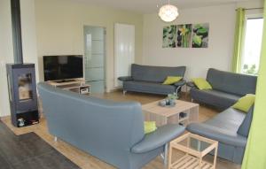 a living room with blue couches and a tv at Lieke in Poperinge