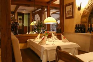 a table in a restaurant with a white table cloth at Hotel Arkade in Leverkusen