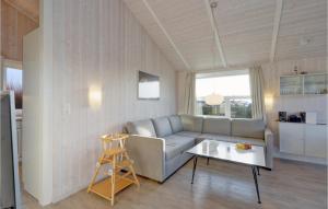 a living room with a couch and a table at Friedrichskoog-Strandpark 9 in Friedrichskoog +24 photos