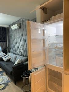 an open refrigerator in a living room with a couch at My G yoo Apartment #1 in Istanbul +37 photos