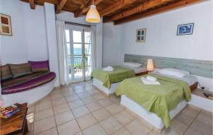 a bedroom with two beds and a couch and a tub at Gorgeous Home In Pomos in Pomos +2 photos