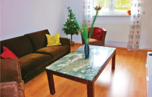 a living room with a couch and a table with a vase at 1 Bedroom Awesome Apartment In Bastorf in Bastorf