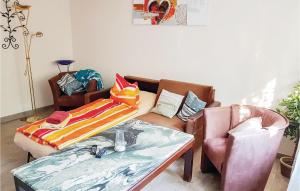 a living room with a couch and a table at 1 Bedroom Awesome Apartment In Bastorf in Bastorf