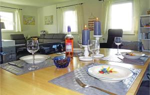 a dining room table with plates and wine glasses at Awesome Apartment In Boiensdorf in Boiensdorf