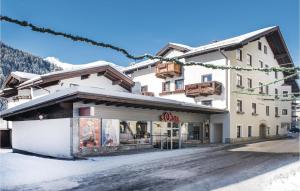 a building with a store on a snowy street at Beautiful Apartment In Rauris With 1 Bedrooms And Wifi in Rauris
