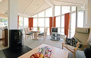 a large living room with a table and chairs and a living room with at Strandblick 23 - Dorf 1 in Travemünde