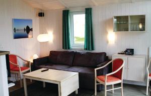 a living room with a couch and a table and chairs at Dnenpark 2c - Dorf 4 in Travemünde
