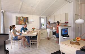 a group of people standing in a kitchen at Dnenpark 2c - Dorf 4 in Travemünde