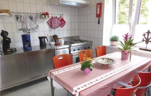 a kitchen with a table with orange chairs and a stove at Nice Home In Auerbach With Wifi in Auerbach