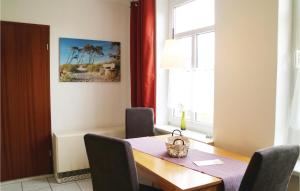 a dining room with a wooden table and a window at 1 Bedroom Pet Friendly Apartment In Brgerende in Börgerende-Rethwisch