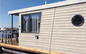 a small house on a dock with a table at 1 Bedroom Gorgeous Ship In Loitz in Loitz