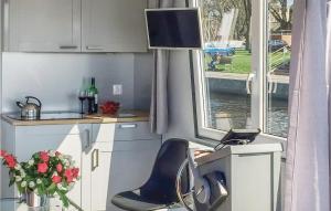 a kitchen with a chair and a table and a window at Awesome Ship In Loitz With House Sea View in Loitz