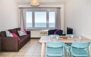 a living room with a table and chairs and a couch at Residentie Aurore Ref 208 in Ostend