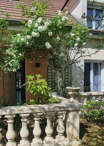 a stone fence with flowers on it in front of a house at Hello Disneyland Paris in Bussy-Saint-Georges