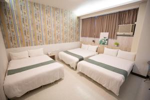 Postel nebo postele na pokoji v ubytování Jia-Jia Business Hotel