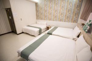 Postel nebo postele na pokoji v ubytování Jia-Jia Business Hotel
