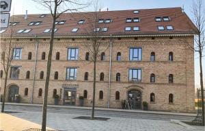 a large brick building with a red roof at Stunning Ship In Neuruppin With House Sea View in Neustrelitz