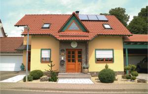 a yellow house with an orange roof at Cozy Apartment In Schlotheim With Kitchen in Schlotheim