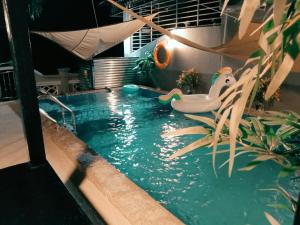 a swimming pool with a bath tub in the water at Private pool Cassa Dinies, Wifi , Bbq,10 pax in Rantau Panjang