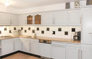 a white kitchen with white cabinets and a sink at 3 Bedroom Amazing Apartment In Paessens in Paesens