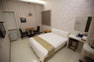 Postel nebo postele na pokoji v ubytování Jia-Jia Business Hotel