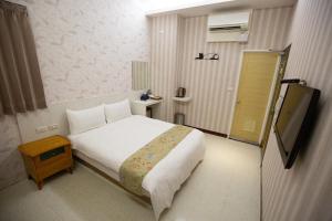 Postel nebo postele na pokoji v ubytování Jia-Jia Business Hotel
