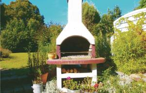 a birdhouse in a garden with flowers and plants at Beautiful Apartment In Kühlungsborn in Kühlungsborn