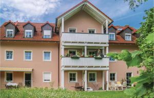 a large pink building with a balcony at Amazing Apartment In Heinersreuth With Wifi in Heinersreuth