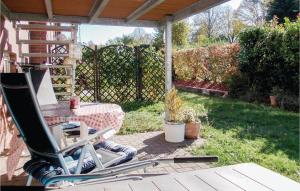 a table and a chair on a patio at Beautiful Apartment In Kühlungsborn in Kühlungsborn +11 photos