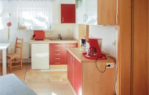a kitchen with a red appliance on top of a counter at Amazing Apartment In Khlungsborn With 1 Bedrooms And Wifi in Kühlungsborn