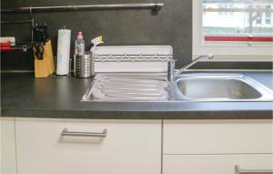 a kitchen sink with a dish drying rack next to it at Gorgeous Home In Breegejuliusruh in Juliusruh +12 photos