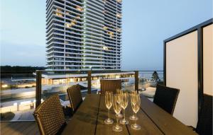 a wooden table with wine glasses on a balcony at Highend Travemünde - Whg 511 in Travemünde +26 photos