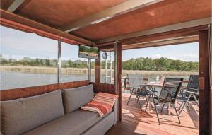 a couch on a boat with a view of the water at Hafen Loitz in Loitz
