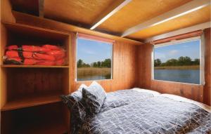 a bedroom with a bed and a window in a boat at Hafen Loitz in Loitz