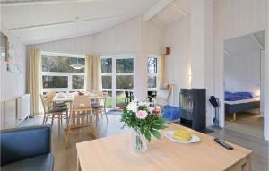 a living room with a vase of flowers on a table at Abendrot 3 - Dorf 3 in Priwall +19 photos