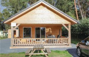 a log cabin with a porch and a deck at Stunning Home In Wilsum With 2 Bedrooms And Wifi in Wilsum