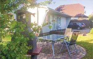 a patio with a table and chairs in front of a house at Holiday Home Dranske Alte Gärtnerei in Dranske