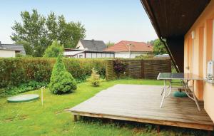 a backyard with a wooden deck with a table at Holiday Home Dranske Alte Gärtnerei in Dranske