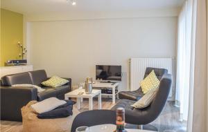 a living room with two couches and a table at Sun Garden in Ostend
