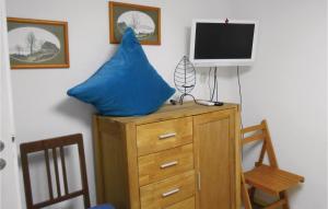 a blue pillow on top of a dresser with a tv at Stunning Home In Spangenberg With Wifi in Spangenberg