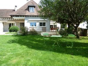 un patio con mesa y sillas frente a una casa en Chambres d'hôtes Le Saleix en Donzenac